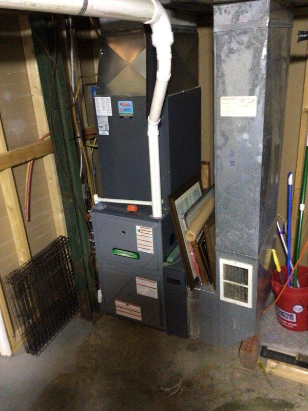 Completed second annual Gold Level planned maintenance visit on 3-year-old single-system HVAC unit. Performed comprehensive inspection of furnace and air handler components, verified proper operation of all mechanical systems, and documented equipment condition with photographic records showing basement installation with vertical furnace unit, PVC condensate drainage, and metal ductwork assembly. Inspected 20x25x4 polarized filter housing and confirmed airflow pathways clear of obstructions.