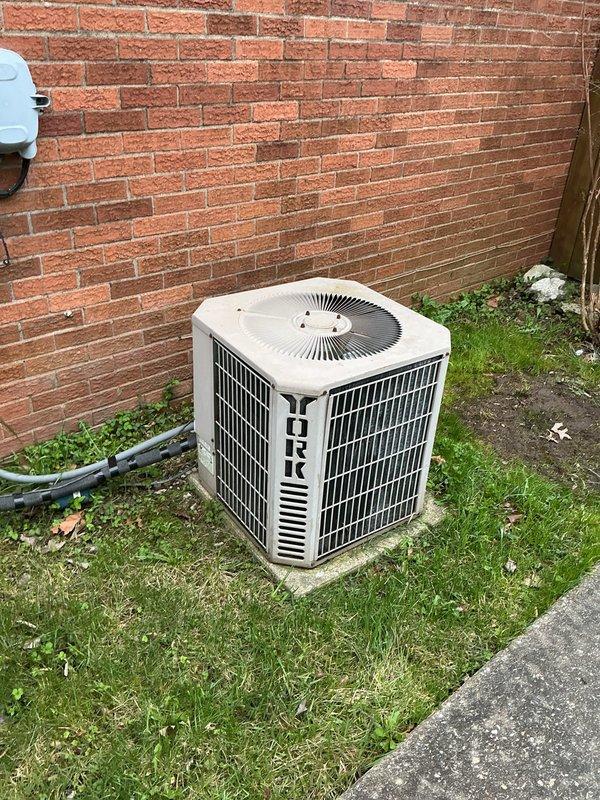 Responded to service call for non-functional thermostat on 20-year-old York air conditioning system with Whirlpool furnace. Replaced failed thermostat with basic non-programmable unit per homeowner request. Verified proper system operation and thermostat communication with HVAC equipment following installation. System restored to normal functionality with heating and cooling capabilities confirmed operational.