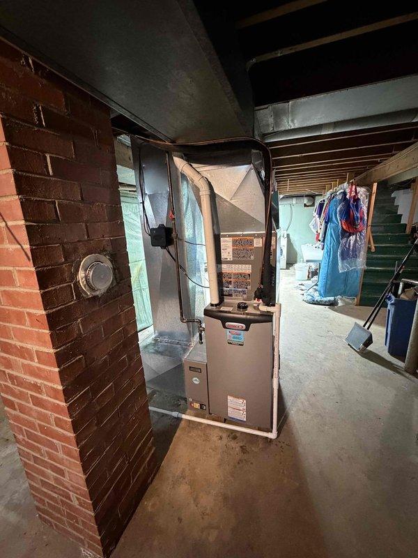 Completed installation of 2-ton, 18 SEER air conditioning system with 97% AFUE upflow furnace in basement location. System commissioning verified proper static pressures with manometer readings of 169 and 160, confirming optimal airflow through ductwork and equipment operation within manufacturer specifications.
