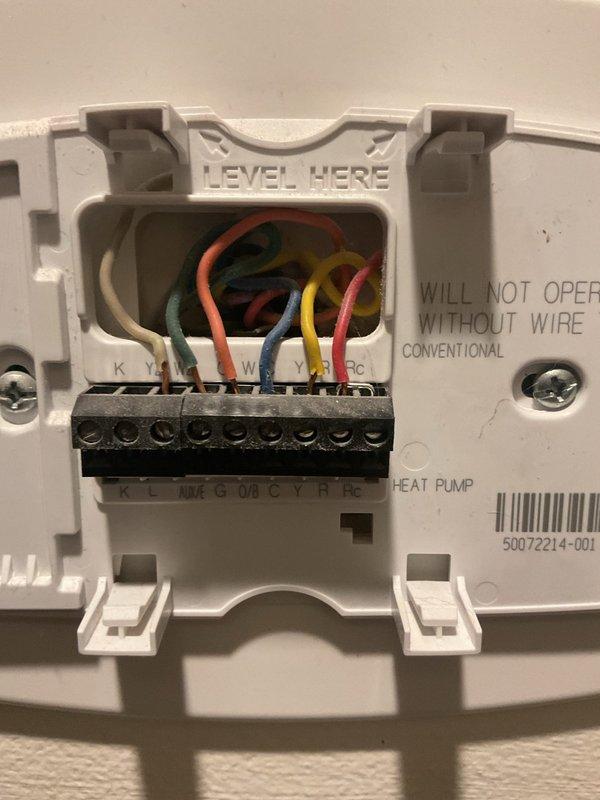 Conducted comprehensive HVAC replacement estimate for non-operational aging system. Documented existing thermostat wiring configuration showing heat pump setup with multiple wire connections to terminal block. Identified critical safety concern with main electrical panel exhibiting extensive burn marks, heat damage, and charred discoloration around multiple circuit breakers, indicating previous electrical overheating or arcing events. Provided homeowner with detailed replacement options and recommendations addressing both failed HVAC system and electrical panel safety hazards requiring immediate attention.