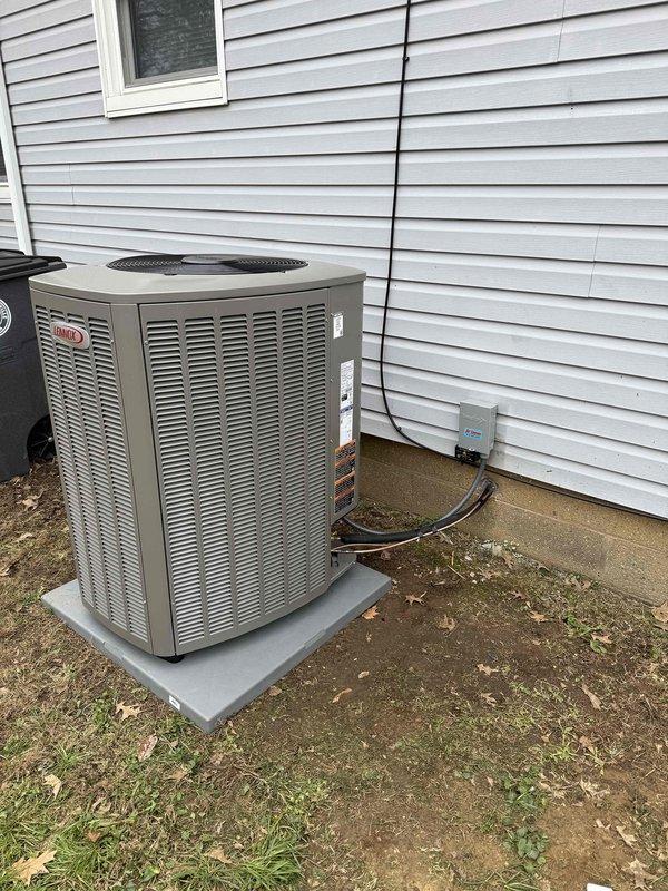 Completed installation of a 2-ton, 18 SEER Lennox cooling system with a 97% AFUE upflow furnace in the basement mechanical room. Installed outdoor condenser unit on concrete pad with proper electrical disconnect and refrigerant line connections, along with PVC intake and exhaust venting for high-efficiency furnace operation, ensuring all components meet manufacturer specifications and local code requirements.