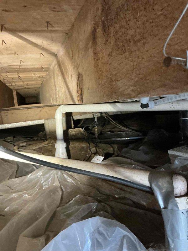 Installed new PVC drainage piping system in attic crawl space, including horizontal drain lines with proper elbow fittings and flexible trap connections. Routed white electrical wiring and coordinated installation with existing mechanical systems including flexible ductwork and vapor barrier materials to ensure proper clearances and code compliance.