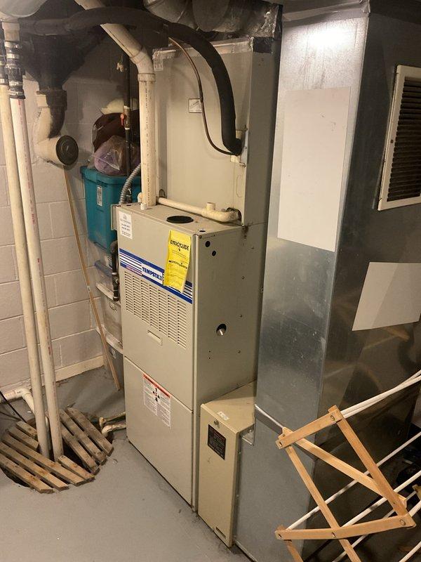 Conducted comprehensive HVAC system evaluation for residential property experiencing cooling inadequacy during extreme temperatures and compressor slamming issues. Existing 15+ year-old air conditioning unit showing signs of refrigerant freeze-up during peak demand periods, with outdoor condenser exhibiting environmental wear and reduced efficiency. Provided complete system replacement estimate including new high-efficiency cooling equipment and compatible furnace options to address capacity limitations and reliability concerns.