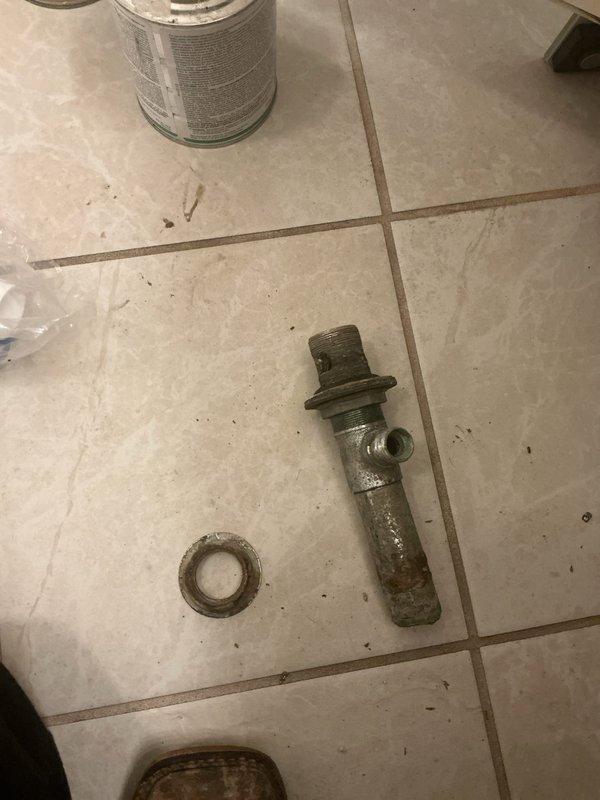 Responded to callback for leak under bathroom sink following recent service visit. Upon inspection, discovered failed corroded pipe fitting causing water seepage beneath vanity. Removed deteriorated metal valve component showing significant oxidation and verdigris buildup. Replaced defective fitting with new assembly, installed fresh washer, and tested faucet operation under full water flow. Verified no leaks present at connections and confirmed proper drainage. Issue resolved and system returned to normal operation.