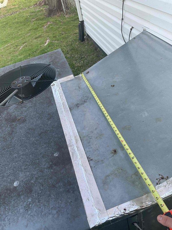 Conducted comprehensive HVAC replacement estimate for existing packaged heating and cooling system showing significant weathering and operational age. Evaluated outdoor unit positioned on concrete pad with proper electrical connections and refrigerant lines, documenting current system configuration including condenser and air handler components. Measured equipment spacing and assessed installation area accessibility, photographed existing system condition with visible dirt accumulation and surface deterioration, and provided homeowner with detailed replacement options for upgraded high-efficiency HVAC system to improve comfort and energy performance.