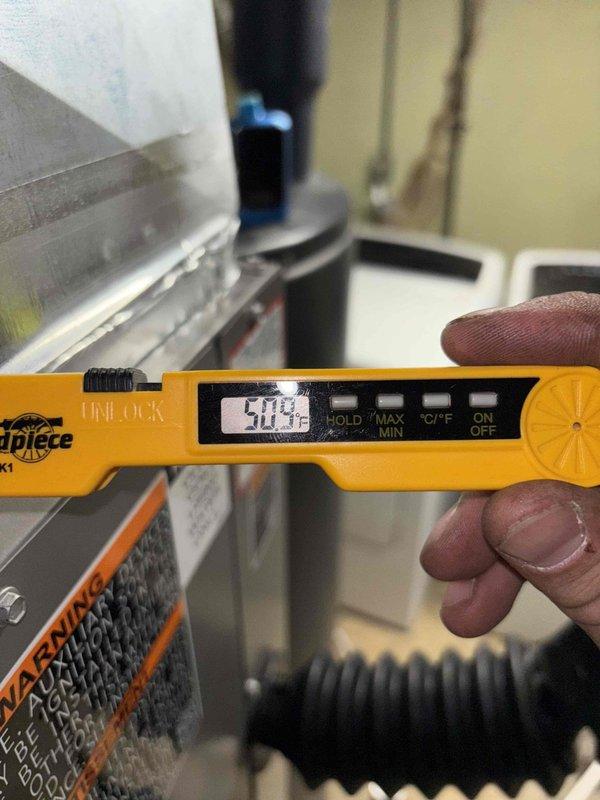 # HVAC Install - Complete System

Completed full system installation of residential HVAC equipment including furnace and associated ductwork in basement utility area. Performed comprehensive system verification and temperature diagnostics, confirming supply air temperature of 50.3°F at the air handler. Installation includes properly secured black flexible ductwork connections, integrated air filter housing with return air system, and all necessary piping connections. System tested and operational with all components functioning within manufacturer specifications.