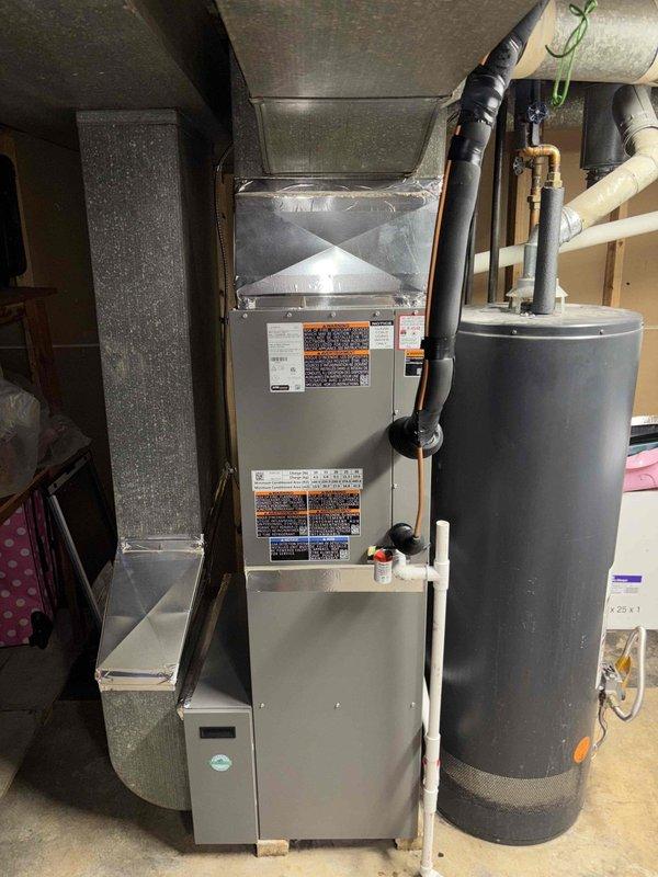 # HVAC Install - Complete System

Completed full system installation of residential HVAC equipment including furnace and associated ductwork in basement utility area. Performed comprehensive system verification and temperature diagnostics, confirming supply air temperature of 50.3°F at the air handler. Installation includes properly secured black flexible ductwork connections, integrated air filter housing with return air system, and all necessary piping connections. System tested and operational with all components functioning within manufacturer specifications.