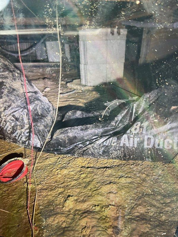 Responded to service call for detached ductwork in residential HVAC system. Upon inspection, found flexible duct sections had become disconnected, likely due to animal activity in the crawlspace or attic area. Documented interior condition of ductwork showing accumulated debris and deterioration consistent with compromised connections. Assessed air handler unit and surrounding duct connections, noting the 2-year-old system was otherwise functioning properly with no heating or cooling performance issues. Photographed damaged sections and discussed repair options with homeowner prior to proceeding with any corrective work per customer request.