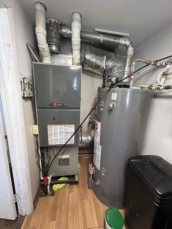 # HVAC Service Call - No Cooling Issue

Responded to service request for 15-year-old residential air conditioning system experiencing cooling problems. Upon arrival, performed comprehensive system evaluation of indoor Trane furnace/air handler unit and outdoor condensing unit.

## Work Performed

Conducted visual inspection of indoor air handler located in utility closet, checking electrical connections, condensate drainage system, and ductwork integrity. Verified proper airflow through supply and return ducts. Inspected PVC condensate drain lines for blockages or restrictions.

Performed outdoor unit assessment, examining condenser coil condition, fan motor operation, and refrigerant line connections. Tested electrical disconnect and verified proper voltage supply to unit. Evaluated compressor operation and measured system pressures.

Given the age of the system at 15 years, thoroughly checked for common failure points including capacitor degradation, contactor wear, and refrigerant l