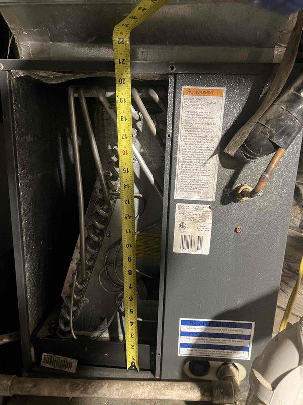 # HVAC Service Completed

Responded to service call for 9-year-old air conditioning system running but not cooling properly. Upon arrival, performed comprehensive diagnostic evaluation of the cooling system and indoor air handler unit.

Conducted visual inspection and measurements of internal components, including refrigerant lines, electrical connections, and junction box terminals. Opened furnace access panel to examine heat exchanger and internal ductwork configuration. Documented system measurements and component conditions with detailed photographs for service records.

Identified failed component affecting cooling performance and completed necessary replacement to restore proper system operation. Verified all electrical connections at terminal block were secure and properly fastened. Inspected condensate drain lines and PVC venting system for proper drainage and clearance.

System returned to normal cooling operation following repairs. Customer requested name of replaced part and