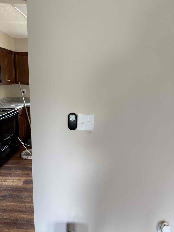 Performed comprehensive electrical inspection of residential property including basement and main living areas. Verified proper installation and functionality of smoke detector mounted to ceiling joists in unfinished basement area. Inspected electrical wiring routed along exposed joists, confirming secure cable management and compliance with code requirements. Checked HVAC system electrical connections and verified proper grounding of mechanical equipment. Examined structural support posts and ensured no electrical hazards were present near metal columns.

Inspected main floor electrical components including wall-mounted switches, doorbell system, and low-voltage devices. Verified proper operation of dual-switch light switch plate and confirmed secure mounting of all wall-mounted electrical fixtures. All systems tested and found to be functioning properly with no safety concerns identified.