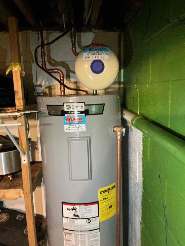 Responded to water heater leak that had been active for one to two weeks. Removed and replaced failed unit with new A.O. Smith standard residential tank water heater, model 2741-JR1C-H4R4. Completed full installation including copper piping connections for inlet and outlet lines, water treatment device mounted at top of unit, and proper venting. Tested all connections for leaks, verified proper operation, and ensured unit met manufacturer specifications and code requirements.