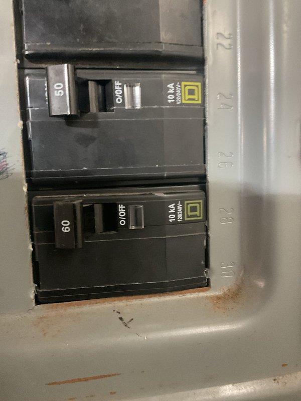 Performed comprehensive system evaluation on 21-year-old HVAC equipment in 2,300 sq ft bilevel home experiencing complete loss of cooling due to refrigerant depletion. Documented existing air conditioning and furnace conditions, photographed electrical service connections including 50-amp and 60-amp breakers at panel, and assessed installation area in basement utility space. Provided detailed replacement options for both standalone AC unit and complete HVAC system upgrade based on equipment age, current system failure, and home specifications.