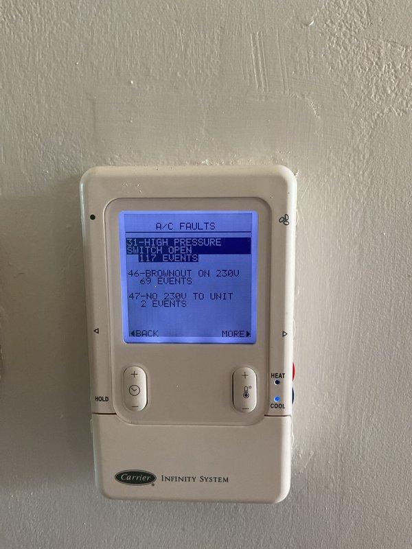 Responded to service call for Carrier Infinity system displaying fault codes and shutting down completely. Upon arrival, found thermostat reporting multiple A/C faults including high pressure switch open (117 events), brownout on 230V (69 events), and no 230V to unit (2 events). Inspected outdoor unit's electrical panel and internal components including control board, wiring connections, and capacitor. Diagnosed electrical supply issues and high pressure switch failures causing system lockouts. Utilized diagnostic equipment to test voltage levels and verify proper power delivery to unit. Addressed underlying electrical concerns and high pressure switch malfunction. Cleared fault codes from Infinity thermostat system. Tested system operation to ensure proper cooling function restored and verified unit running without further error codes or shutdowns.