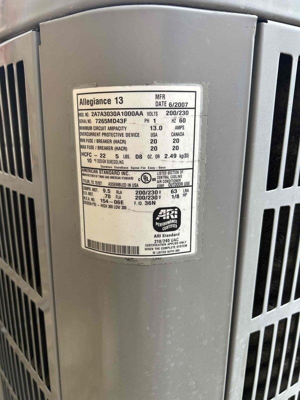 Conducted comprehensive assessment of existing American Standard Allegiance 13 SEER outdoor condensing unit manufactured in 2007. Documented current system specifications including model 24YR303QA1000AA operating at 200/230V with 13.0 amp circuit capacity. Evaluated electrical infrastructure including exterior disconnect box, conduit routing, and power supply connections. Photographed equipment nameplate data and existing installation conditions to provide detailed replacement estimate for upgraded high-efficiency HVAC system.