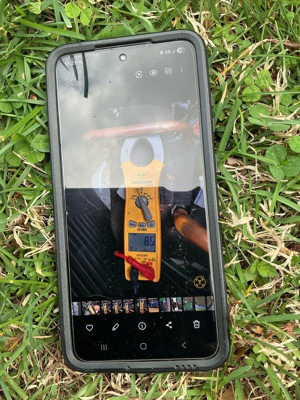 Responded to warranty follow-up call for heat pump system less than one year old displaying "OU Inverter" error code and inadequate heating performance with thermostat set at 72°F. Diagnosed faulty inverter board on outdoor unit through visual inspection and electrical testing, confirmed system operating in heating mode but with compromised efficiency. Documented inverter board model number, captured detailed photographs of circuit board assembly showing toroidal inductors, integrated circuits, and component layout, and recorded amperage readings of 8.5A during diagnostic testing. Ordered replacement inverter board under warranty coverage with red priority status due to reduced heating capacity, estimated two-hour installation time upon part arrival, no additional helper required for completion.