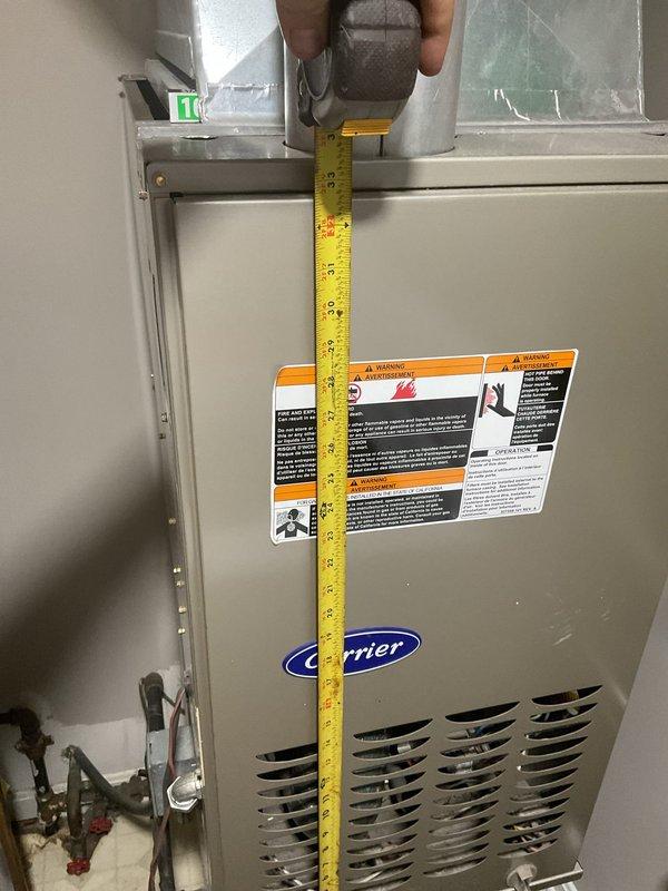 Completed comprehensive HVAC system evaluation for heat pump replacement estimate at residential property. Performed refrigerant leak detection assessment on primary heat pump system and conducted full inspection of secondary garage unit. Documented equipment specifications and measurements of existing Carrier furnace unit and Bradford White water heater (dated 2-10-15) to determine replacement requirements and clearance specifications. Provided detailed replacement estimate with equipment recommendations based on current system age and operational status.