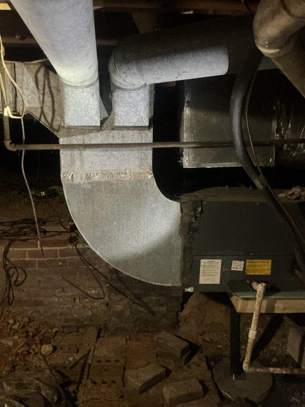 Responded to service call for 21-year-old HVAC system experiencing thermostat failure. Upon arrival, confirmed air handler was operational and circulating air through ductwork, but system was not reaching set temperature due to hardwired thermostat displaying blank screen with no power. Performed diagnostic evaluation of electrical system, inspecting breaker panel to verify power supply to HVAC equipment and thermostat circuit. Identified loss of power to thermostat control circuit while main system continued to operate. Traced wiring from air handler located in basement through insulated ductwork to thermostat location. Verified breaker positions and electrical connections at panel. Diagnosed thermostat power supply issue preventing temperature control and system communication. Restored proper thermostat functionality, allowing system to resume normal heating/cooling cycles and reach desired temperature settings.