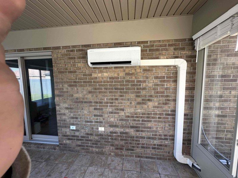 # HVAC Installation Completed

Successfully installed a 9,000 BTU ductless mini-split air conditioning system in a covered outdoor patio area. The installation included mounting the indoor evaporator unit on the brick wall, running refrigerant lines concealed in white PVC line cover, establishing proper drainage, and completing all electrical connections to code. System was tested and verified operational upon completion.