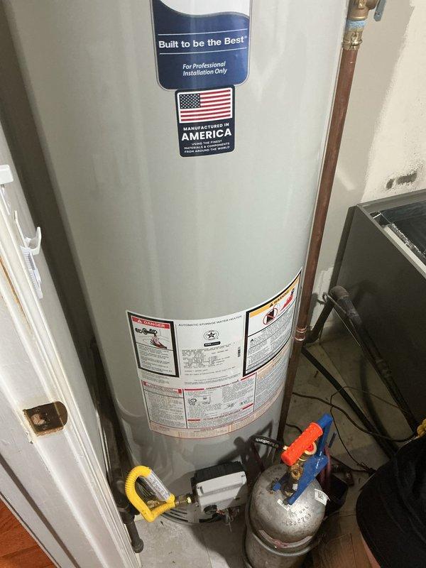 Installed a new 40-gallon tall gas water heater manufactured by Bradford White in the utility closet. Connected copper supply lines with dielectric unions to prevent galvanic corrosion, installed proper shut-off valves including gas isolation valve, and vented the unit with galvanized metal flue pipe per code requirements. All plumbing connections were tested and verified leak-free, and the unit was commissioned successfully.