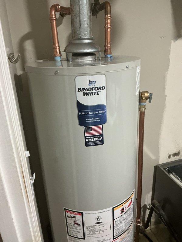Installed a new 40-gallon tall gas water heater manufactured by Bradford White in the utility closet. Connected copper supply lines with dielectric unions to prevent galvanic corrosion, installed proper shut-off valves including gas isolation valve, and vented the unit with galvanized metal flue pipe per code requirements. All plumbing connections were tested and verified leak-free, and the unit was commissioned successfully.
