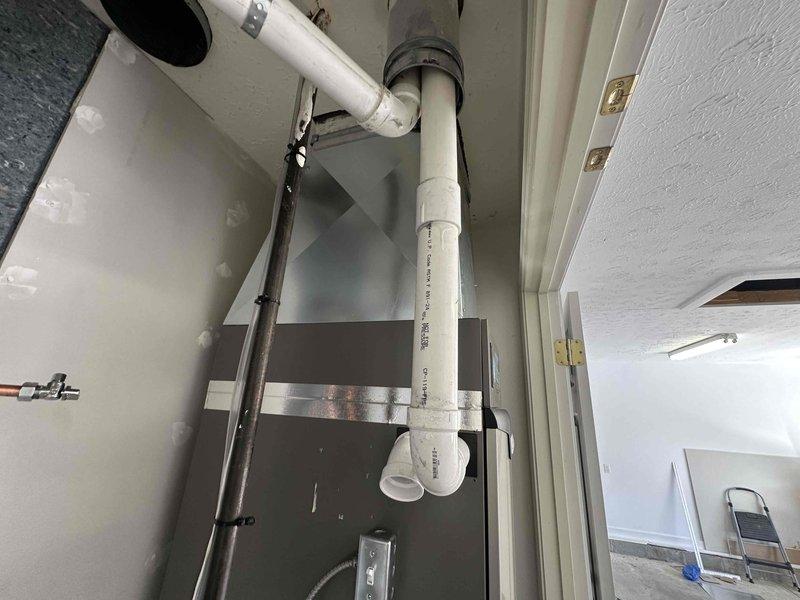 Completed full HVAC system installation including a 3-ton Lennox unit with 23.5 SEER rating and 99% efficiency furnace, mounted in utility closet with proper ventilation and clearances. Installed powered humidifier integrated with new system, ran white PVC condensate drainage lines with appropriate pitch and connections, and added supply ventilation ductwork. Water heater was relocated and reconnected with copper supply lines and PVC venting to accommodate new HVAC equipment placement. All components secured with proper mounting brackets, piping labeled and routed efficiently through mechanical space, and system tested for proper operation and airflow.