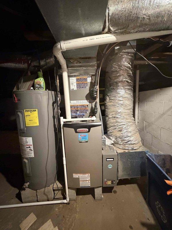 Completed full HVAC system installation consisting of a 2.5-ton, 14 SEER air conditioning unit paired with a 97% AFUE upflow gas furnace in basement location. System installed per manufacturer specifications with proper venting, condensate drainage via PVC piping, and flexible ductwork connections to existing distribution system. All electrical connections completed, thermostat wired, and system tested for proper operation and airflow.