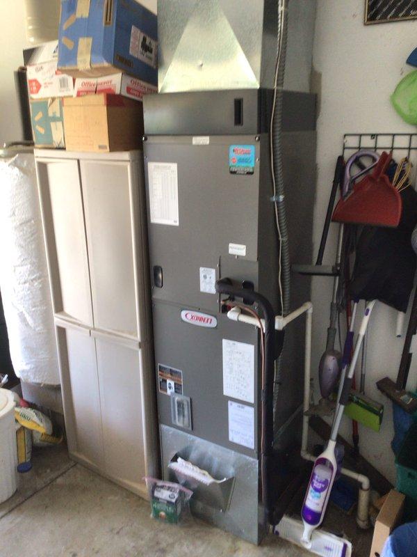 Performed comprehensive planned maintenance tune-up on Lennox residential furnace system located in garage utility area. Completed full system inspection, verified operational parameters on Honeywell Home thermostat displaying proper temperature control at 67 degrees, and documented equipment condition with photos showing unit accessibility and proper installation environment.