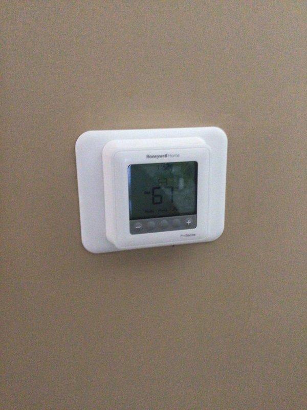 Performed comprehensive planned maintenance tune-up on Lennox residential furnace system located in garage utility area. Completed full system inspection, verified operational parameters on Honeywell Home thermostat displaying proper temperature control at 67 degrees, and documented equipment condition with photos showing unit accessibility and proper installation environment.