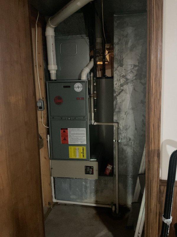 Conducted comprehensive assessment of existing HVAC system and water heater for replacement estimate. Evaluated 35-year-old furnace and air conditioning unit along with 42-year-old water heater, all of which have exceeded their expected service life and require replacement. Documented existing upflow furnace configuration in basement utility room, including measurements and clearances for proper equipment sizing. Provided detailed replacement quotes covering complete HVAC system upgrade, including furnace, air conditioner, and water heater options with both standard tank and tankless configurations to meet homeowner preferences.