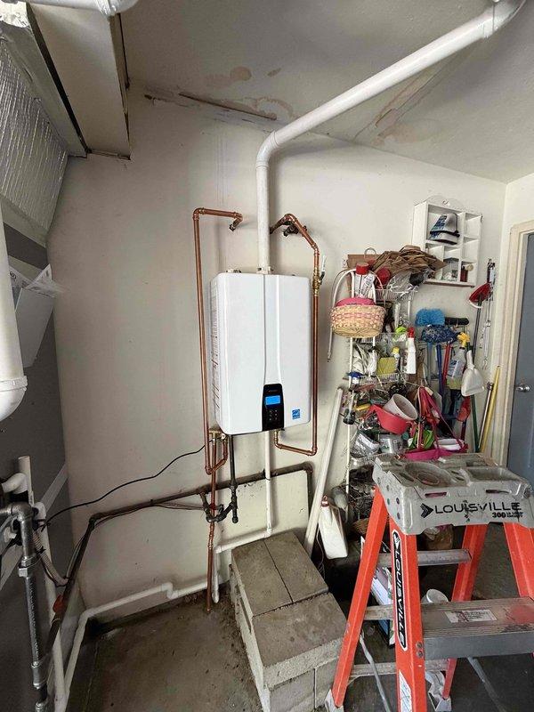 Completed full HVAC system installation including a 3-ton 15.5 SEER Lennox outdoor condensing unit (Model ML14KC1-036) with R-454B refrigerant and a tankless water heater system. The outdoor unit was installed with proper electrical connections at 208/230V, single phase, 60Hz specifications. Inside the mechanical room, installed wall-mounted tankless water heater with complete copper piping configuration including multiple shut-off valves for isolation and service access. Routed all refrigerant lines, condensate drainage via white PVC piping, and electrical conduit to code. System was pressure tested, evacuated, charged to manufacturer specifications, and verified for proper operation of both heating and cooling functions.