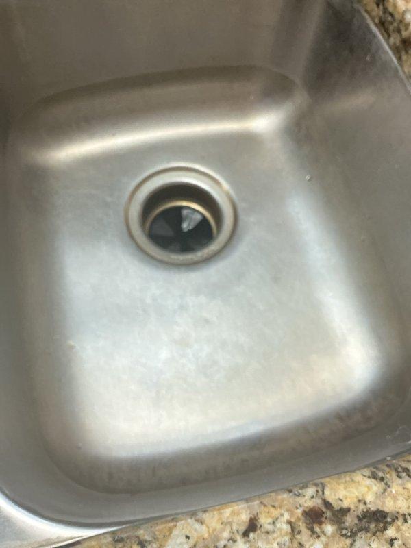 Responded to service call for leaking garbage disposal with water accumulation under sink. Upon inspection, identified active leak at disposal unit causing water damage to cabinet floor. Removed and replaced faulty garbage disposal unit, reconnected drain lines to existing P-trap assembly, and verified proper seal at all connection points. Tested system for leaks, confirmed proper drainage, and cleaned work area.