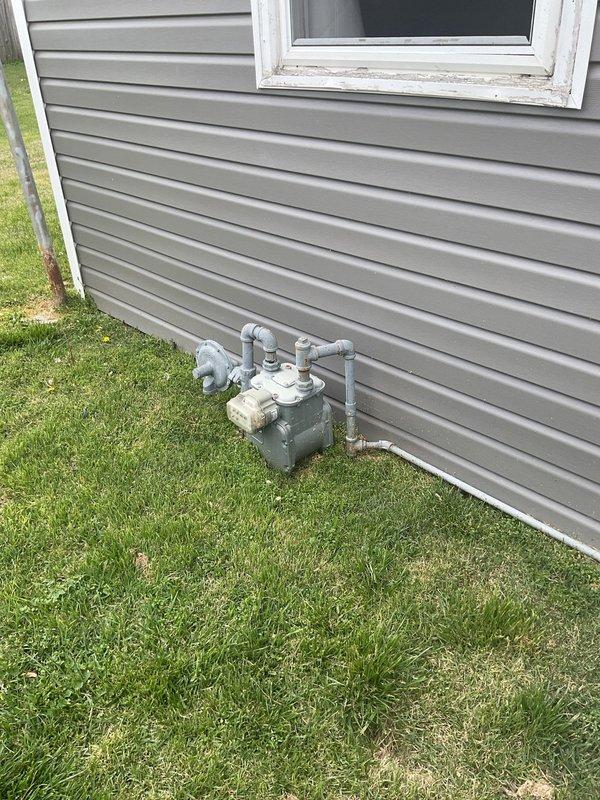 Completed comprehensive HVAC system replacement estimate for residential property with non-functioning existing equipment. Evaluated current outdoor condensing unit and associated ductwork installation, including vertical metal chase and existing concrete pad placement. Assessed natural gas meter location and utility connections for compatibility with replacement system requirements, documented site conditions including siding clearances and electrical service access, and provided homeowner with detailed replacement options during scheduled consultation.