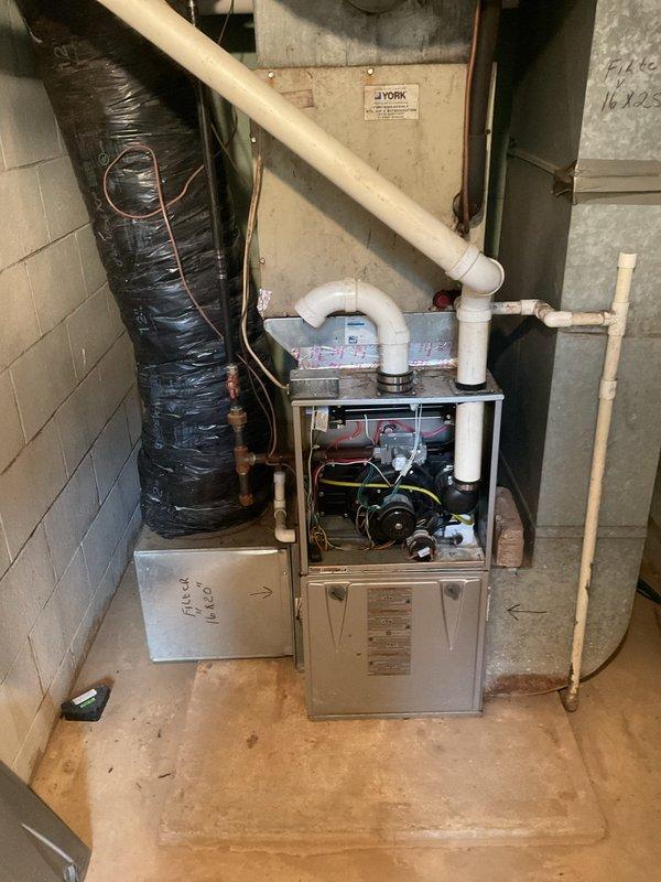 # HVAC Service Report

## Summary
Responded to no cooling complaint on residential air conditioning system. Diagnosed failed contactor with severely corroded contact points preventing compressor operation. Replaced defective contactor, verified proper system operation, and restored cooling functionality.

## Work Performed

Upon arrival, customer reported air conditioning system running but not producing cold air. Confirmed air handler operating normally with adequate airflow at registers. Proceeded to outdoor condensing unit to diagnose cooling failure.

Inspection of outdoor unit revealed condenser fan motor running but compressor not engaging. No visible refrigerant leaks, ice formation, or obvious external damage observed. Removed electrical service panel to access contactor and control components.

Visual inspection identified severely corroded contactor with rust-covered contact points and deteriorated connection surfaces. Corrosion extent indicated prolonged exposure to moisture