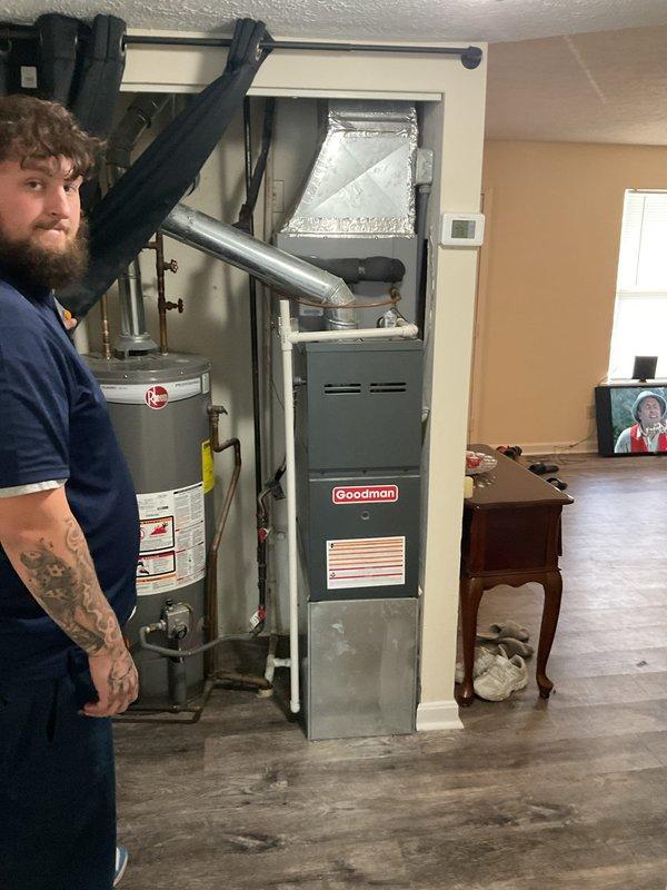 Responded to no cooling complaint on 20-year-old Goodman air conditioning system in apartment unit. Upon arrival, verified warm air discharge from supply registers with no visible ice formation on indoor coil. Inspected electrical panel and confirmed dedicated AC circuit breaker in proper operating position. Evaluated furnace/air handler unit and associated ductwork in basement utility closet. Documented equipment condition and system configuration with photos for service records. System age and lack of cooling capacity indicate likely compressor failure or refrigerant loss requiring further diagnostic testing or replacement consideration.