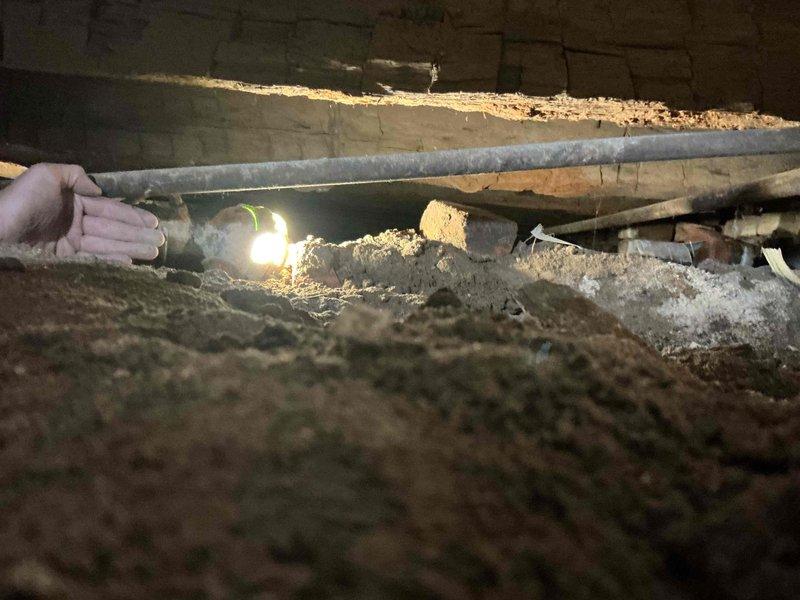 Conducted site assessment of crawl space to provide estimate for installation of two dedicated 120V sump pump circuits. Evaluated existing electrical infrastructure, foundation access points, and routing requirements through confined underfloor area with exposed floor joists and concrete block foundation walls. Documented crawl space conditions including limited clearance, soil floor surface, and structural considerations for proper conduit installation and circuit protection to support dual sump pump system installation.