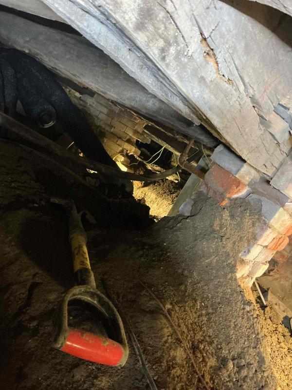 Conducted site assessment of crawl space to provide estimate for installation of two dedicated 120V sump pump circuits. Evaluated existing electrical infrastructure, foundation access points, and routing requirements through confined underfloor area with exposed floor joists and concrete block foundation walls. Documented crawl space conditions including limited clearance, soil floor surface, and structural considerations for proper conduit installation and circuit protection to support dual sump pump system installation.