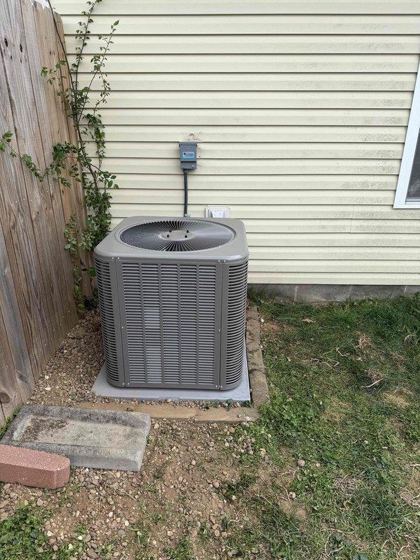 Completed full HVAC system installation consisting of a 2.5-ton, 16 SEER air conditioning condensing unit and 96% AFUE gas furnace. The outdoor condenser was positioned on a concrete pad with proper gravel base against the exterior wall, with electrical disconnect box mounted and conduit properly routed. System was charged with refrigerant, pressures and temperatures were verified using calibrated diagnostic equipment, and all performance parameters were confirmed to be within manufacturer specifications.