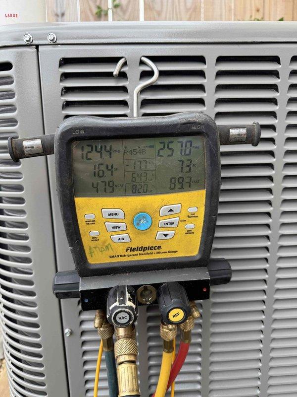 Completed full HVAC system installation consisting of a 2.5-ton, 16 SEER air conditioning condensing unit and 96% AFUE gas furnace. The outdoor condenser was positioned on a concrete pad with proper gravel base against the exterior wall, with electrical disconnect box mounted and conduit properly routed. System was charged with refrigerant, pressures and temperatures were verified using calibrated diagnostic equipment, and all performance parameters were confirmed to be within manufacturer specifications.