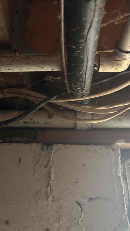 Conducted comprehensive replacement estimate for 25-year-old HVAC system experiencing repeated breaker trips and complete system failure. Evaluated existing outdoor condensing unit with deteriorated components, assessed basement ductwork infrastructure including aged vertical supply trunk with worn insulation and multiple flexible duct runs, and documented electrical disconnect configuration. Provided homeowner with equipment replacement options and system specifications for complete system changeout.