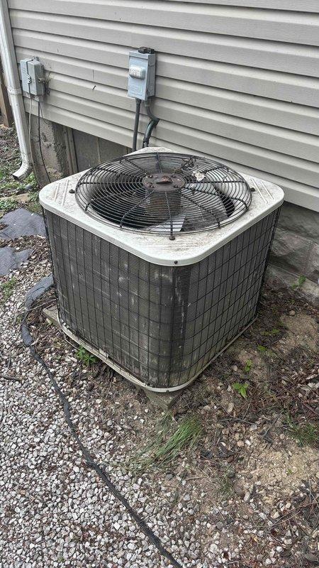 Conducted comprehensive replacement estimate for 25-year-old HVAC system experiencing repeated breaker trips and complete system failure. Evaluated existing outdoor condensing unit with deteriorated components, assessed basement ductwork infrastructure including aged vertical supply trunk with worn insulation and multiple flexible duct runs, and documented electrical disconnect configuration. Provided homeowner with equipment replacement options and system specifications for complete system changeout.