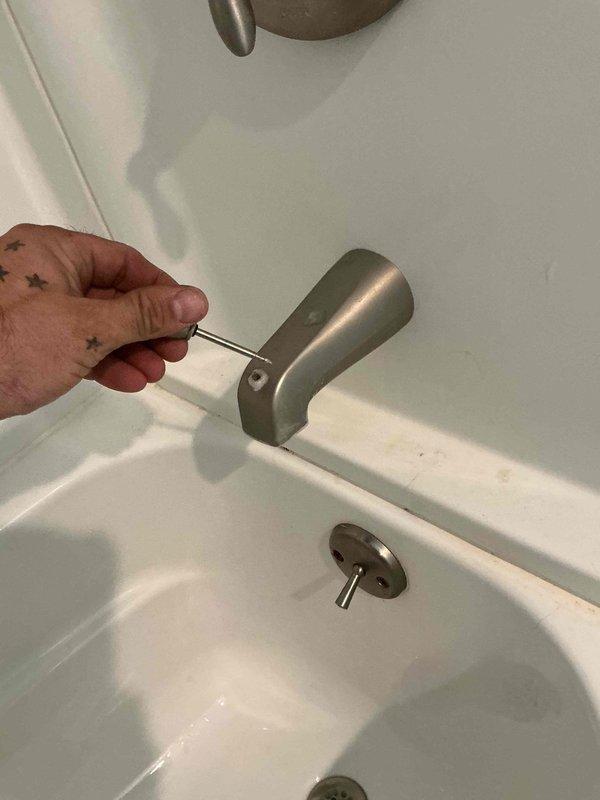 Responded to service call for continuously running toilet and slow-draining shower and sink. Upon arrival, inspected toilet tank components and identified faulty fill valve causing constant water flow. Assessed bathtub drain assembly and confirmed partial blockage consistent with hair accumulation affecting both shower and sink drainage due to shared plumbing line. Removed tub spout access cover to evaluate drain system and prepared recommendations for drain cleaning service to restore proper water flow throughout bathroom fixtures.