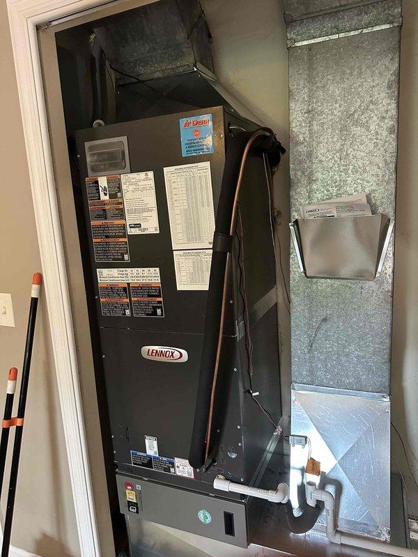 Completed installation of a 2-ton, 19 SEER heat pump system with matching air handler in residential mechanical closet. Installed Lennox air handler unit with proper refrigerant line connections, galvanized ductwork integration, and PVC condensate drain line with appropriate trap configuration. System was charged, tested, and verified operational using digital manifold gauges to ensure proper refrigerant pressures and temperatures across all components.