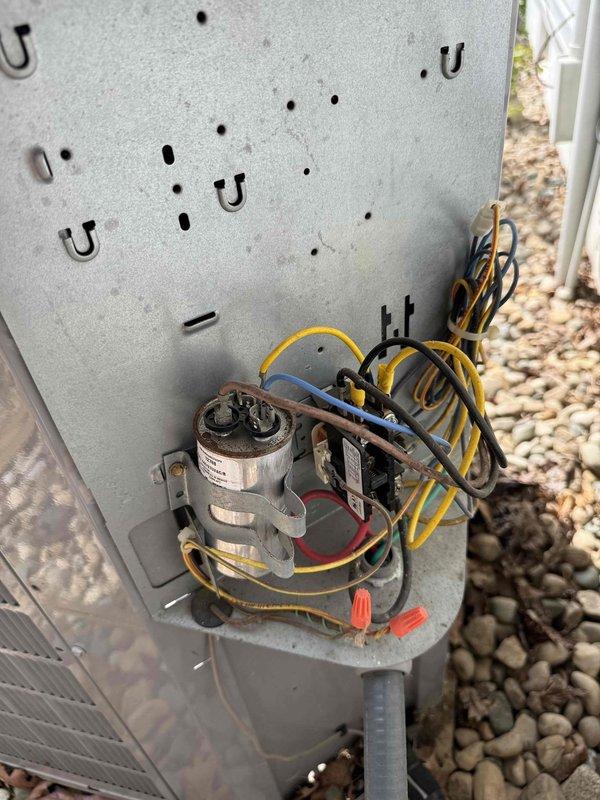 Completed annual Gold Level maintenance on 11-year-old HVAC system. Performed comprehensive inspection of outdoor unit including electrical components, capacitor, and contactor assembly. Verified system operation with temperature readings showing 73.4°F. All electrical connections secure with proper wire routing and orange wire nuts intact. Capacitor and relay components inspected and functioning within normal parameters. System operating efficiently with no issues found during maintenance visit.