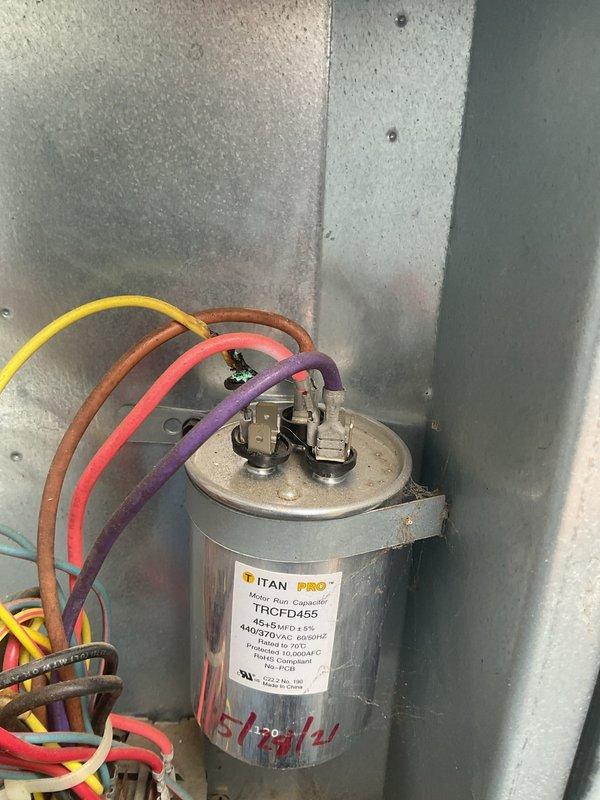 Responded to no cooling complaint on 15-year-old zoned HVAC system with upstairs zone not cooling efficiently. Diagnosed failed dual-run capacitor on upstairs zone air handler. Replaced defective TITAN TRCFD455 capacitor (440/370V) and verified proper electrical connections to compressor and fan motor terminals. Tested zone damper actuators for proper operation and confirmed both zones cycling correctly. System restored to full cooling capacity with all zones functioning normally.