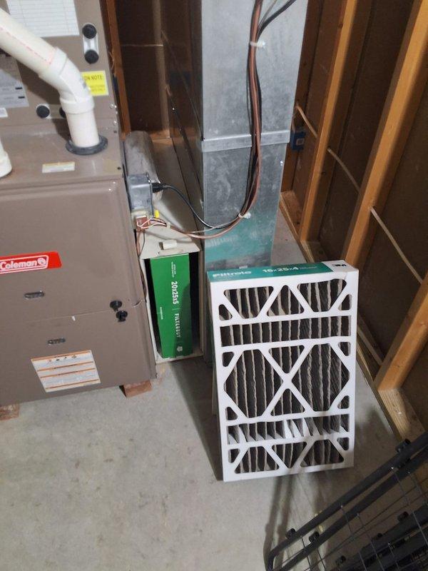 Responded to no cooling call on 10+ year old Coleman HVAC system with complete power failure. Upon arrival, confirmed thermostat was non-responsive with no display, no airflow from vents, and no equipment operation. Performed comprehensive diagnostic of electrical system including main disconnect, breaker panel, and control circuits. Inspected outdoor condensing unit and indoor air handler for power supply issues. Tested low voltage transformer, thermostat wiring, and control board functionality. Identified failed components preventing system startup. Documented existing installation including Coleman furnace with air handler, 16x25x4 filtration system, and outdoor condensing unit mounted on concrete pad with proper refrigerant line connections. Photographed equipment configuration and electrical connections for service records. Provided customer with repair options and recommendations for restoring cooling operation to residence.