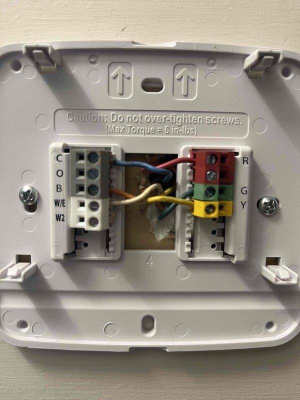 Responded to cooling system complaint with 6-degree temperature differential between thermostat setpoint and actual room temperature. Upon inspection, diagnosed faulty thermostat temperature sensor causing inaccurate readings and preventing proper system cycling. Removed existing programmable thermostat, verified proper wire terminations at R, C, G, Y, W/E terminals, and installed replacement unit. Tested system operation through complete cooling cycle, confirmed accurate temperature sensing, and verified unit now achieving desired setpoint. System restored to proper operation.