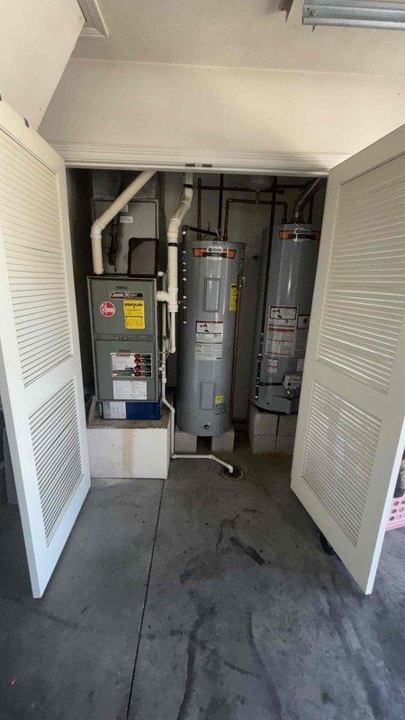Conducted comprehensive replacement estimate for residential HVAC system experiencing inadequate heating and cooling performance. Evaluated existing Rheem air handler unit located in utility closet, assessed ductwork configuration including white PVC condensate lines and insulated supply ductwork, and documented current equipment specifications and installation conditions. Provided homeowner with complete system replacement options to address capacity concerns and improve overall comfort performance.