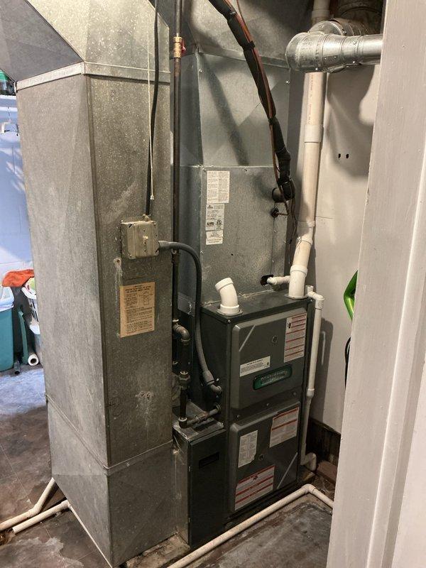Responded to no cooling complaint on five-year-old residential air conditioning system. Upon arrival, performed comprehensive diagnostic evaluation of both outdoor condensing unit and indoor air handler. Inspected refrigerant lines, electrical connections, and verified no ice formation on evaporator coil. Documented equipment condition with photos showing outdoor condenser unit properly positioned on pad with adequate clearance, and indoor air handler installation in utility area with associated ductwork and drainage systems intact. System components appeared to be in good physical condition with normal wear patterns for age. Completed diagnostic assessment and provided findings to customer regarding cooling issue resolution.