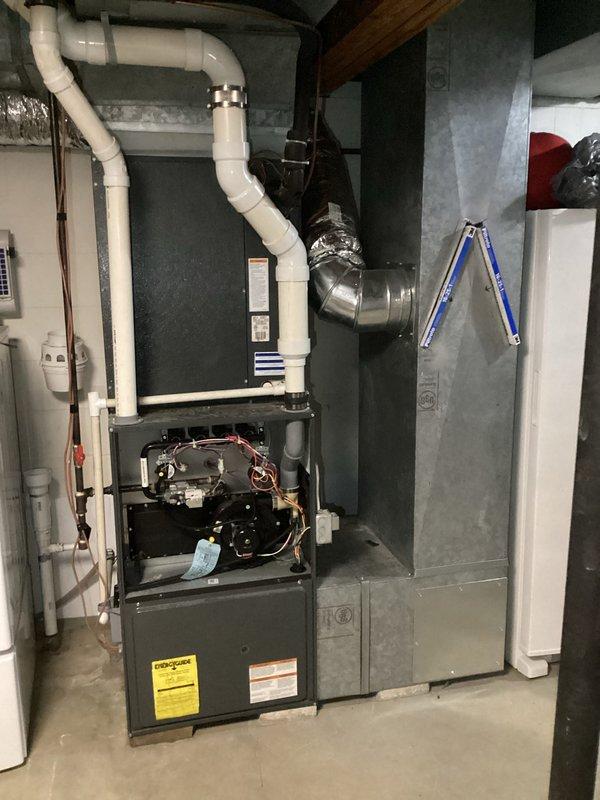 Completed on-site assessment of existing HVAC system for replacement estimate. Documented current furnace installation in basement utility room, including open inspection of internal components, copper coils, wiring, and mechanical systems. Photographed existing equipment configuration showing dark gray/black furnace unit with associated white PVC venting routed to ceiling, metallic duct connections, and surrounding plumbing infrastructure. Recorded measurements and created detailed upflow system schematic diagram showing proposed replacement layout with furnace, coil, and plenum configurations. Documented existing base dimensions at 9x35 on wood flooring in non-deteriorated condition. Captured comprehensive visual documentation of mechanical room environment including galvanized ductwork, ceiling clearances, and available working space for equipment replacement. Provided customer with Green A+ rated replacement system proposal based on current installation parameters and structural me